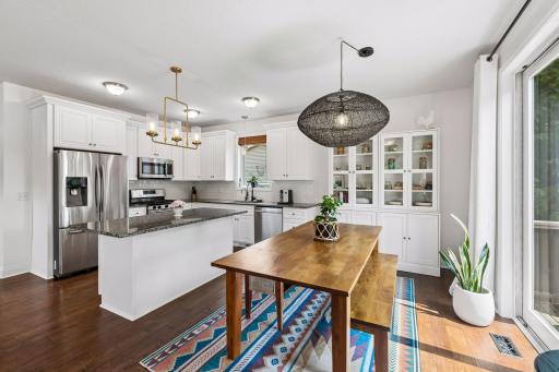 The spacious dining area is filled with natural light and offers easy access to the expansive deck, creating the perfect indoor-outdoor flow for family dinners or entertaining guests.