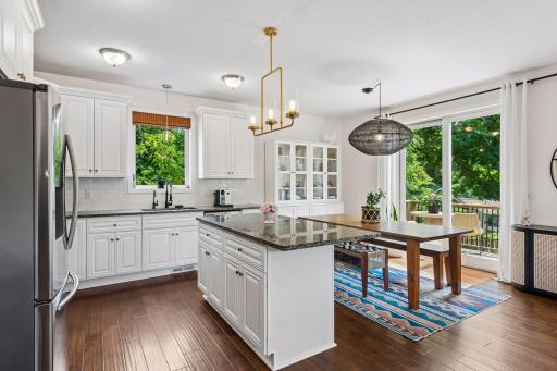 The open-concept kitchen and dining area are designed for everyday living and entertaining. Granite countertops, abundant cabinetry, and direct access to the expansive deck make hosting effortless.