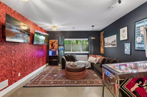 The open-concept lower level seamlessly blends living and recreation spaces, offering flexibility for entertaining on any scale.
