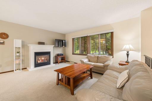 Spacious, sunlit family room with cozy gas fireplace.