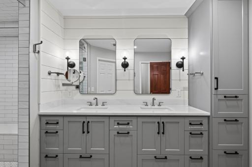 The spacious primary bathroom features dual sinks and abundant storage, making busy mornings effortless