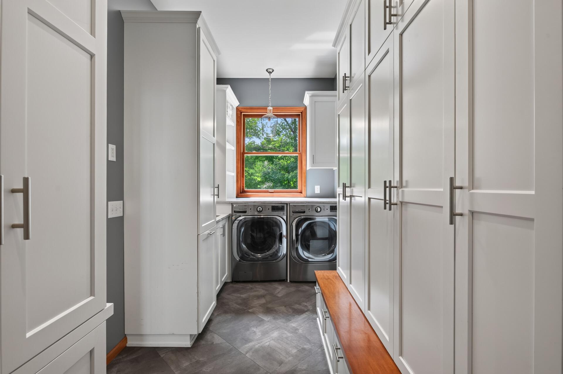 Main level washer in the mudroom and dryer plus storage for days