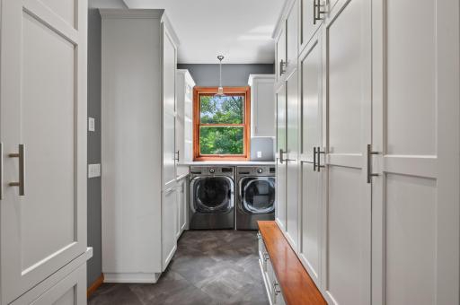 Main level washer in the mudroom and dryer plus storage for days