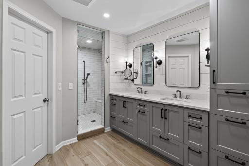 Love the primary bathroom with heated tile floors, a spa-like steam shower, double vanities