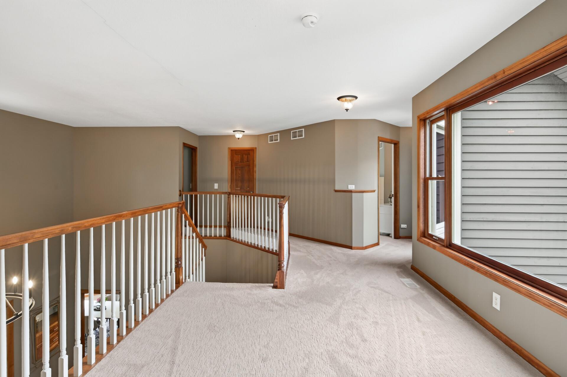 The upper level offers four bedrooms, including two with private ensuite bathrooms and two connected by a Jack-and-Jill bath with separate vanities, providing comfort and privacy for family and guests alike.