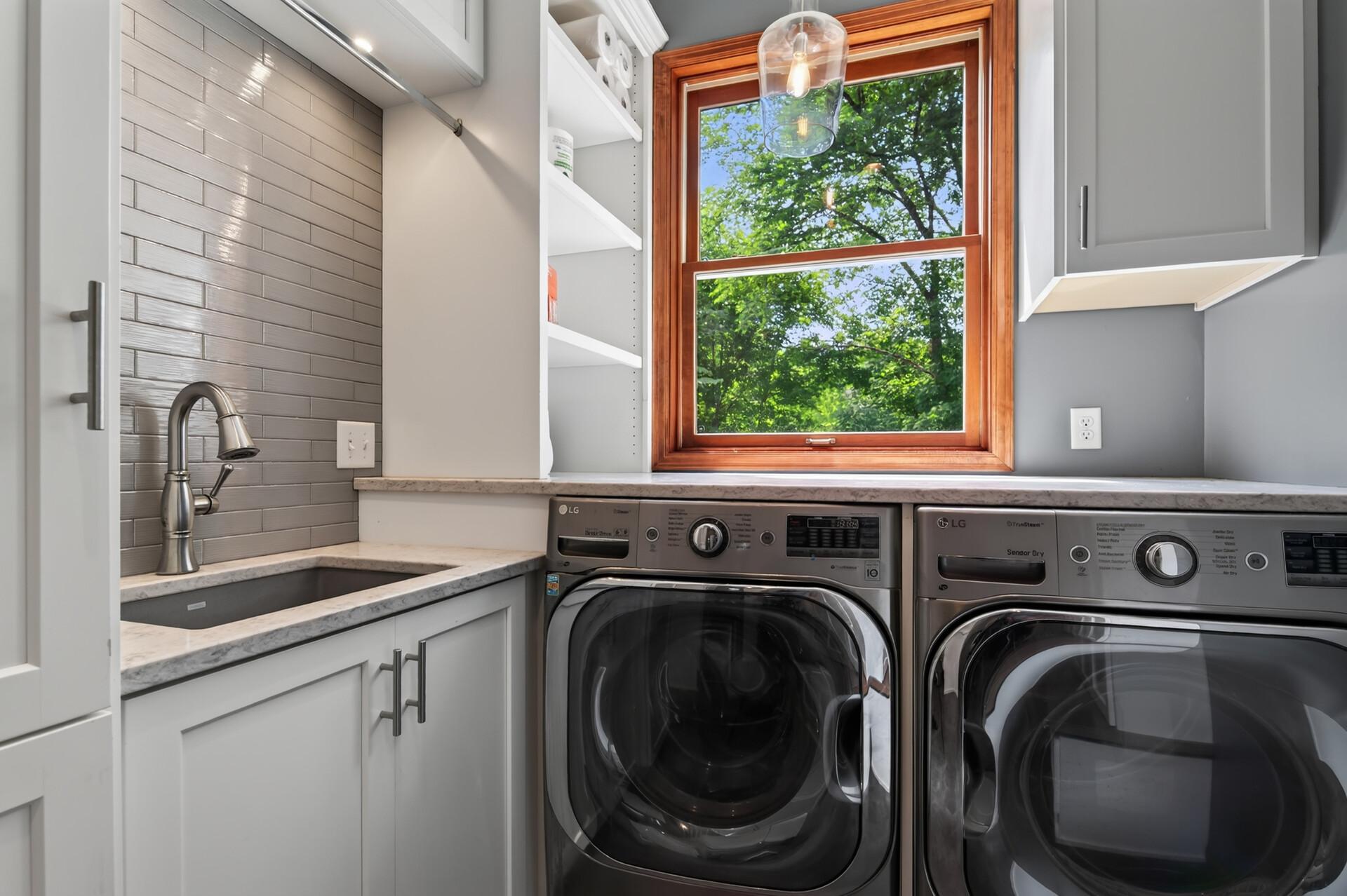 The heated garage includes custom sports lockers for storing equipment, while the spacious mudroom/laundry area provides abundant storage and keeps backpacks, shoes, and gear neatly organized.