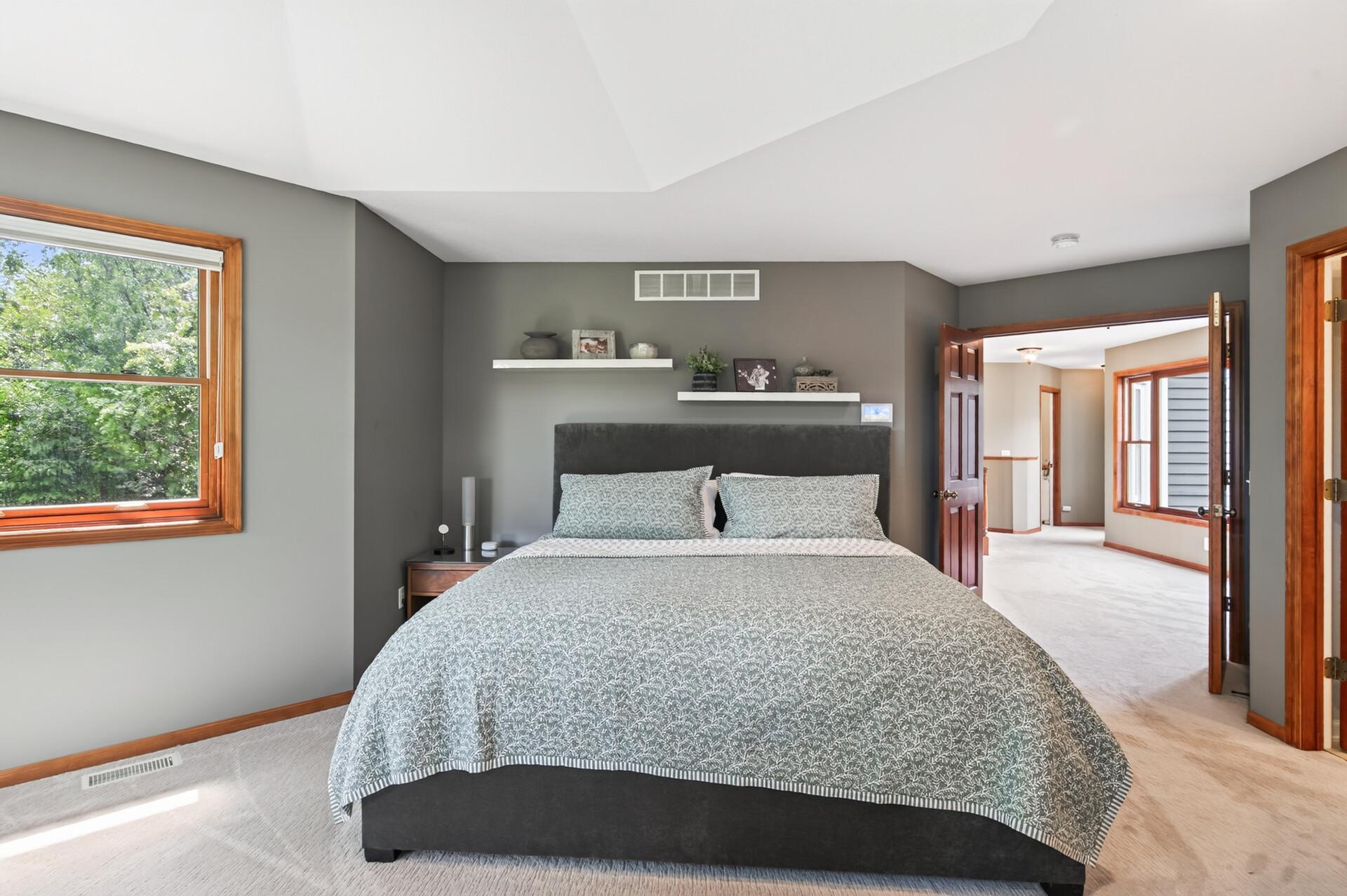 The spacious primary suite easily accommodates an oversized California king bed, with plenty of room to spare for additional furniture