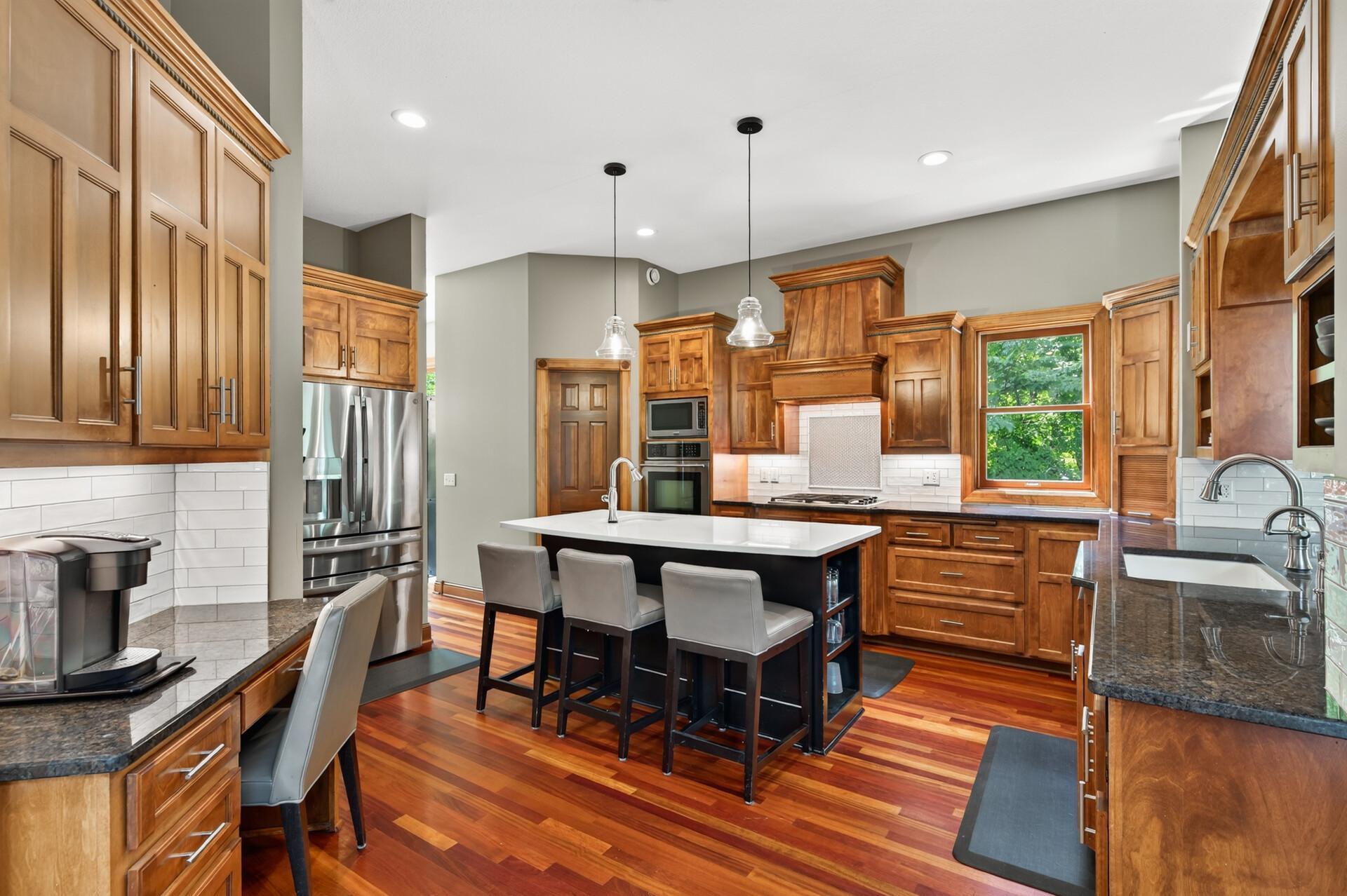 Chef's kitchen featuring two sinks, expansive countertop space, and a layout designed for effortless cooking, entertaining, and gathering