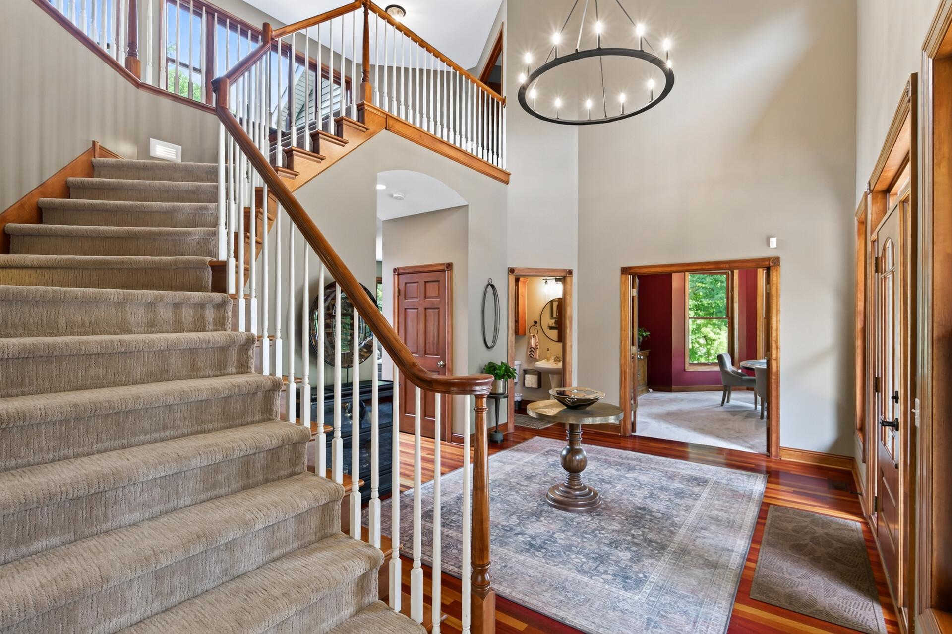 A gorgeous curved wood staircase creates a stunning focal point as it leads to the second floor