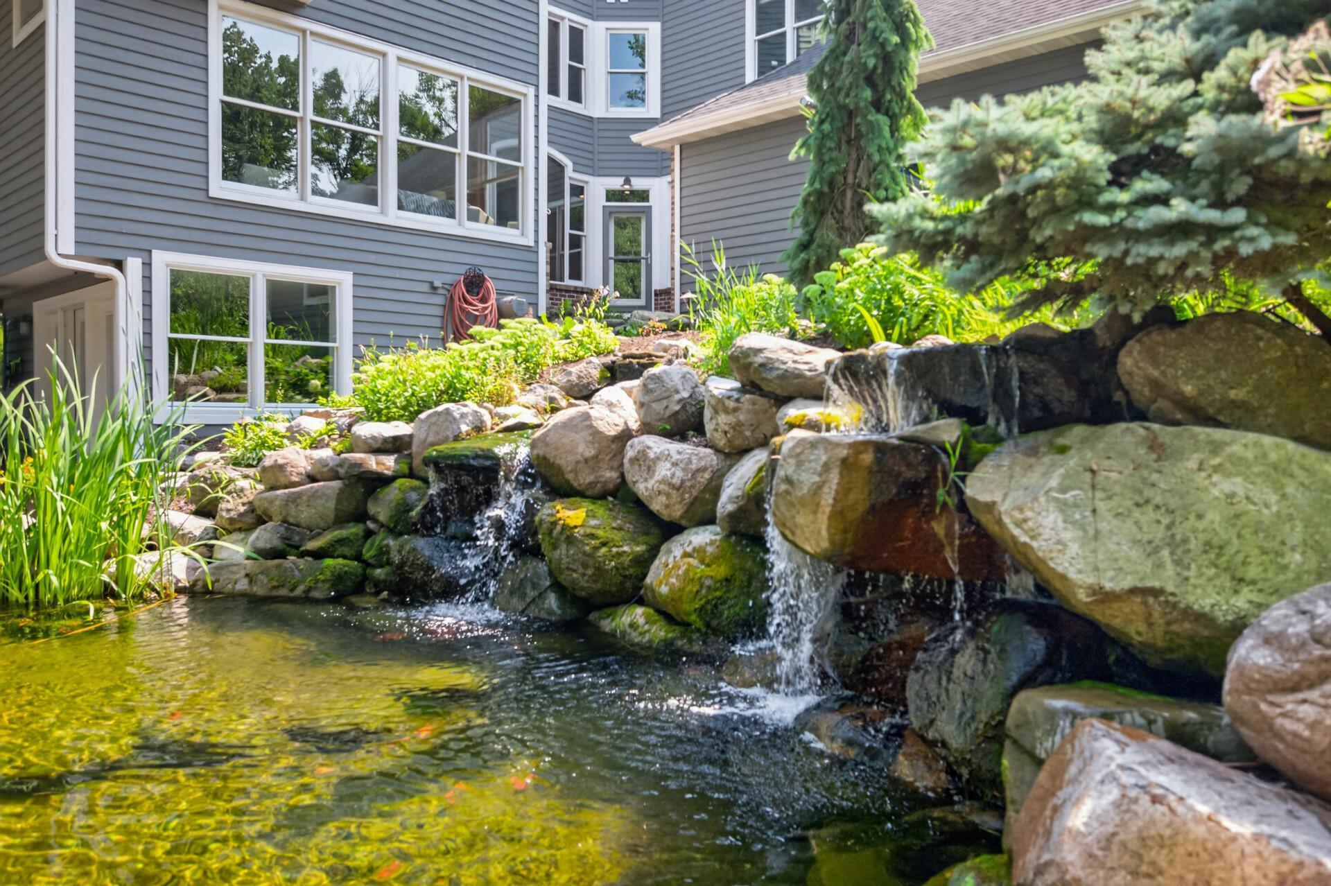 The backyard is complete with a stunning cascading waterfall, adding beauty and tranquility to the outdoor space