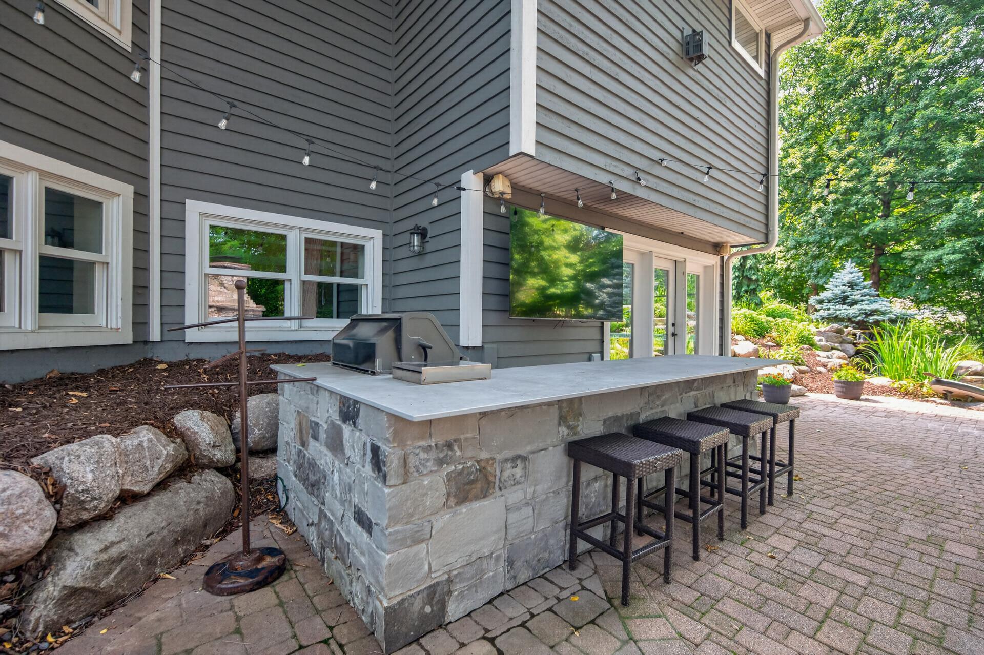 Cement and stone bar with a 75 inch TV