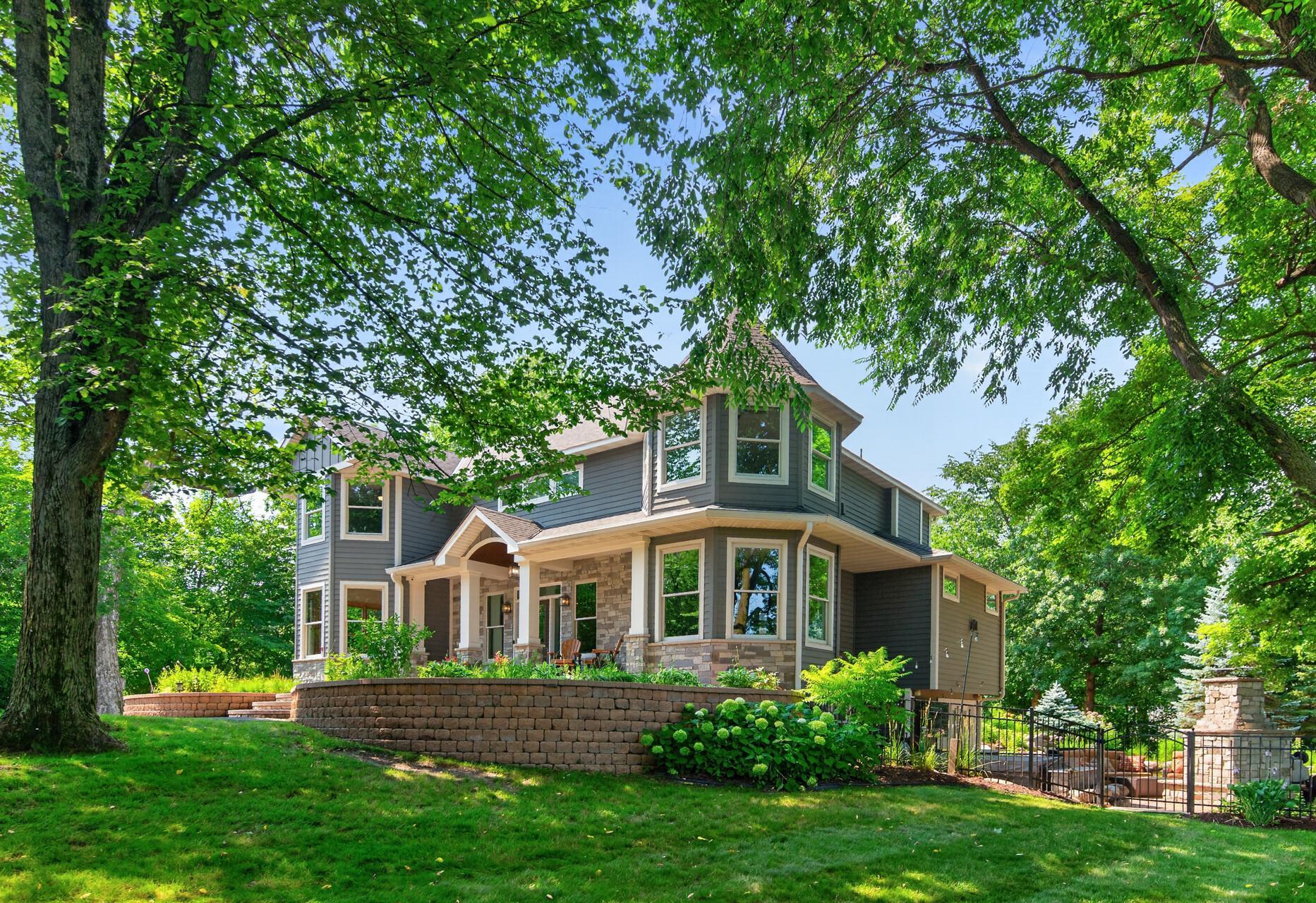 A stunning Craftsman-inspired home nestled among towering trees, offering timeless architecture, exceptional curb appeal, and a private, resort-like setting