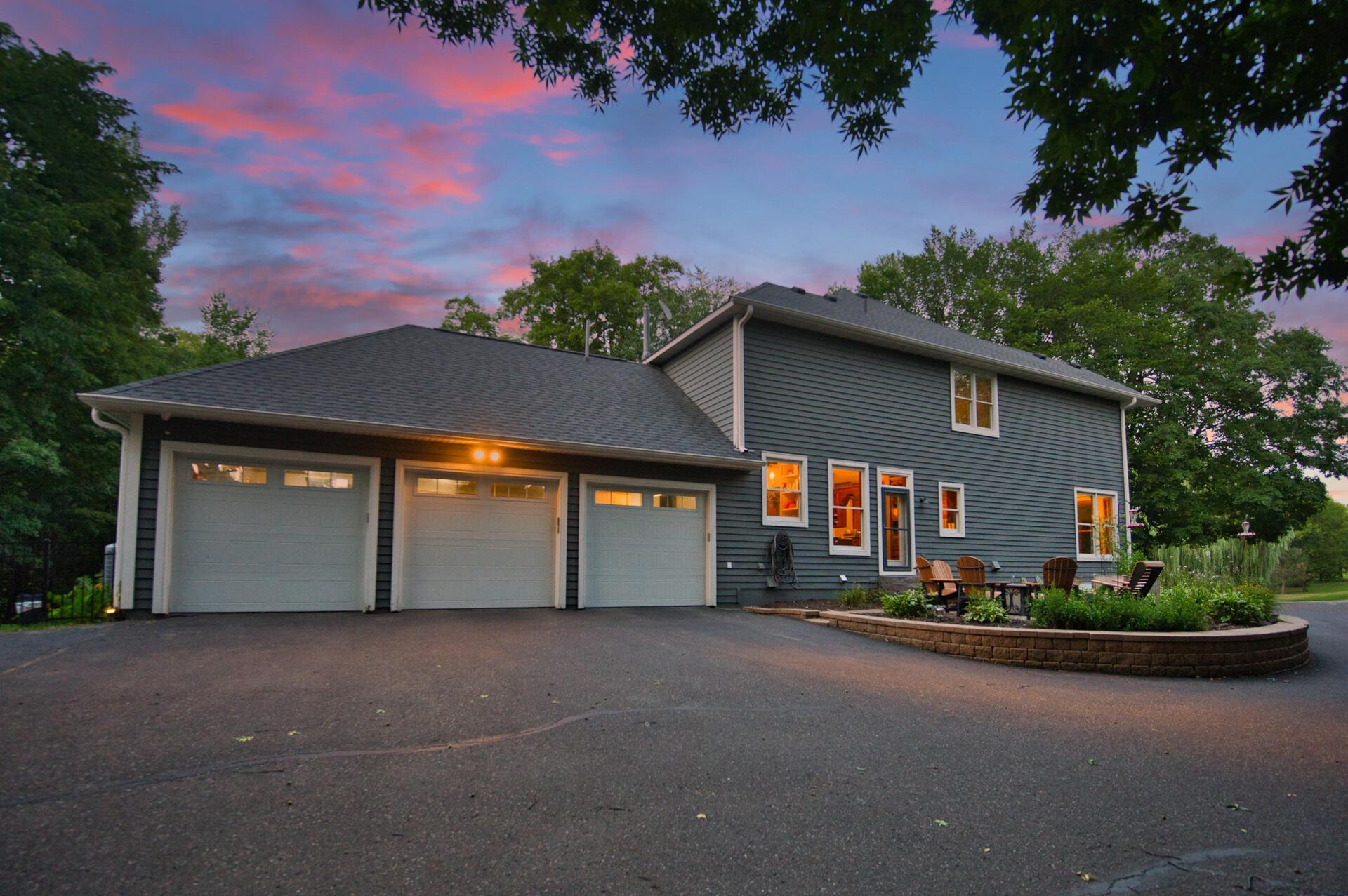 3 car heated garage with extra outdoor parking spots for the kiddos on the side