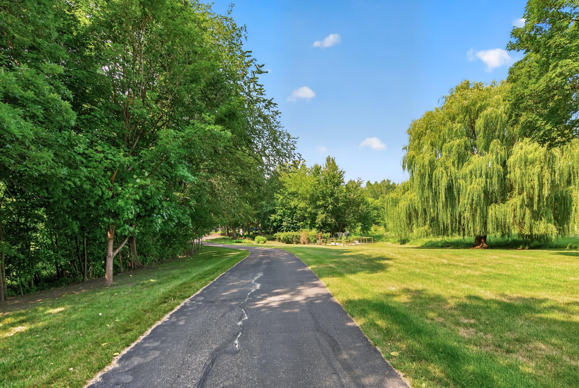 Tucked well back from the road, this private setting is surrounded by mature trees, fruit trees, and garden space, offering peace, beauty, and room to roam.
