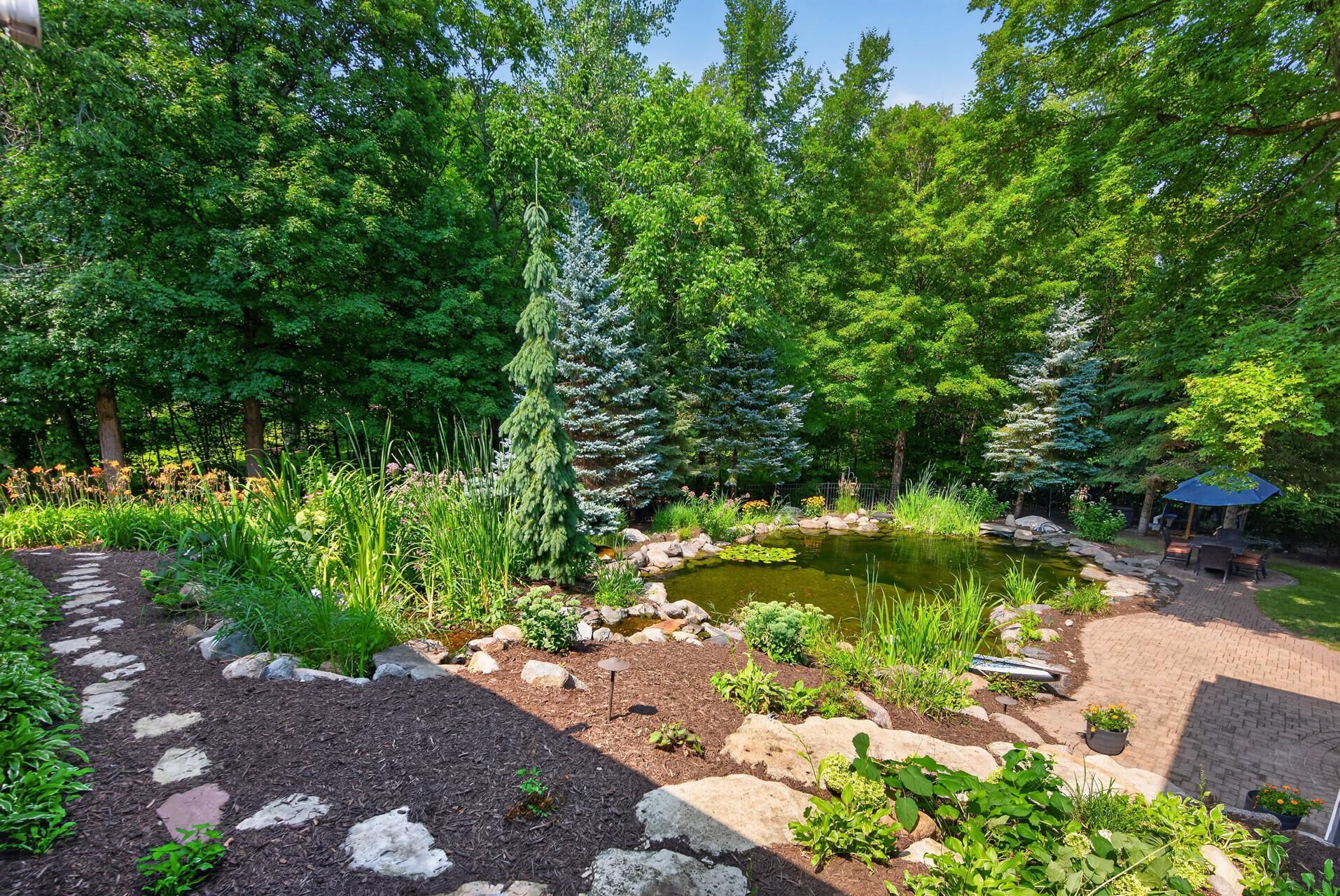 The natural pond pool is maintained by MN Waterscapes, it offers a one- of-a-kind outdoor experience that feels like having your own private lake.