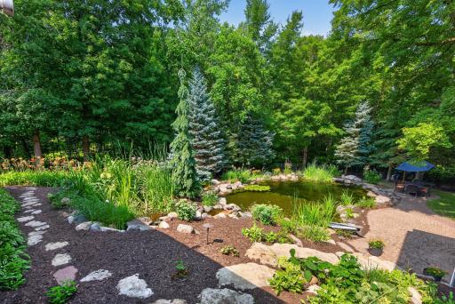 The natural pond pool is maintained by MN Waterscapes, it offers a one- of-a-kind outdoor experience that feels like having your own private lake.