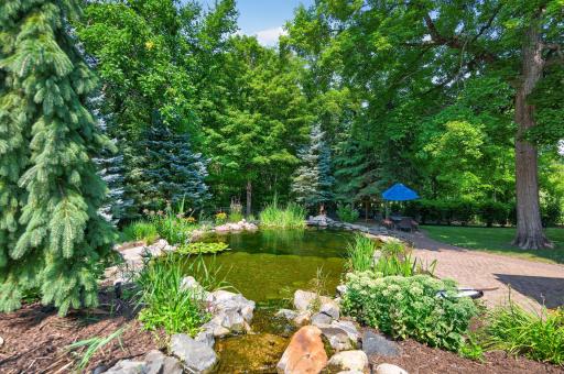 A flat rock in the deep end creates the perfect jumping spot, while the pond gradually transitions from approximately 4 feet to 12 feet deep.