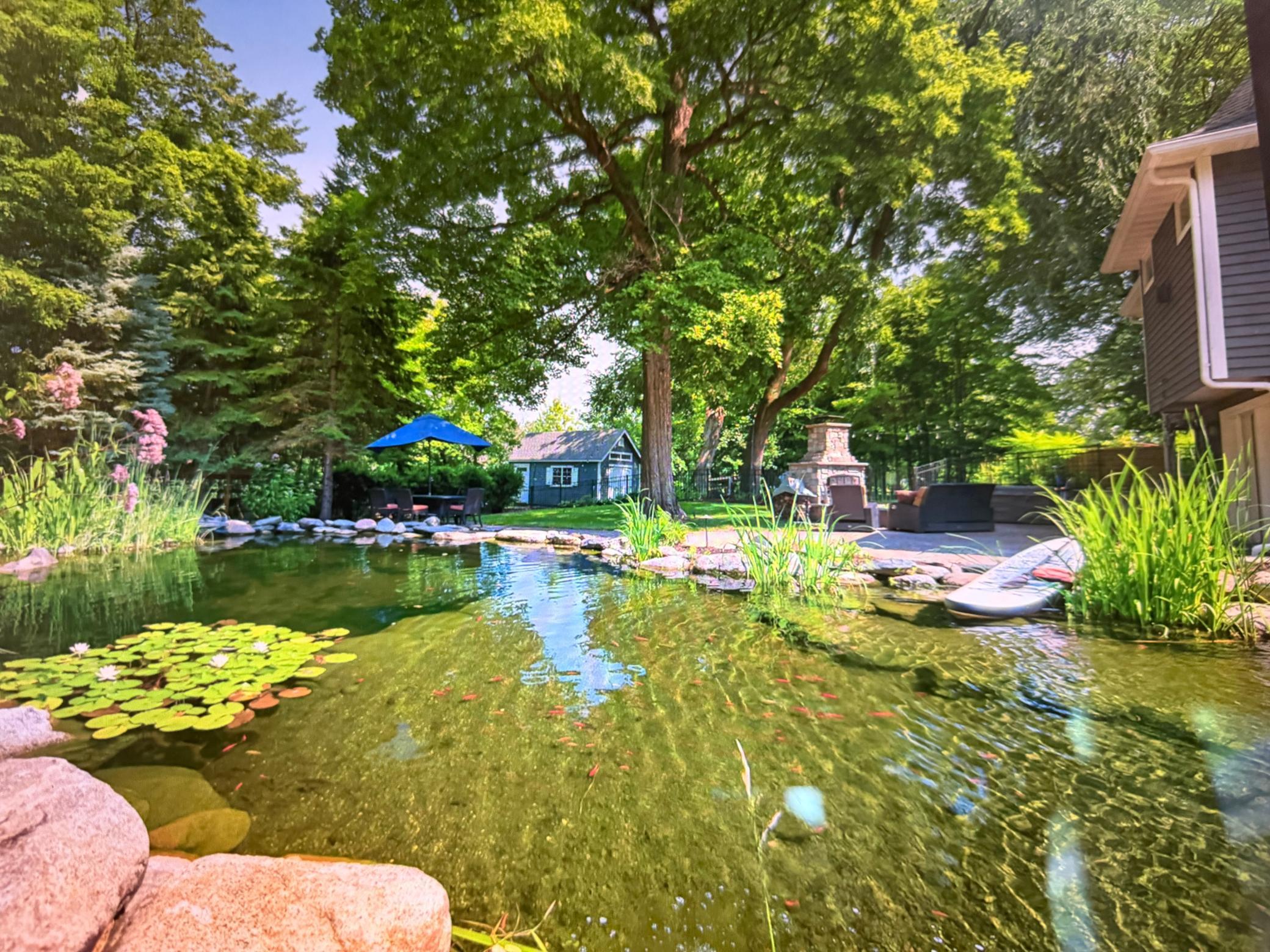 One-of-a-kind natural swimming pond with stunning waterfall features and a commercial heater