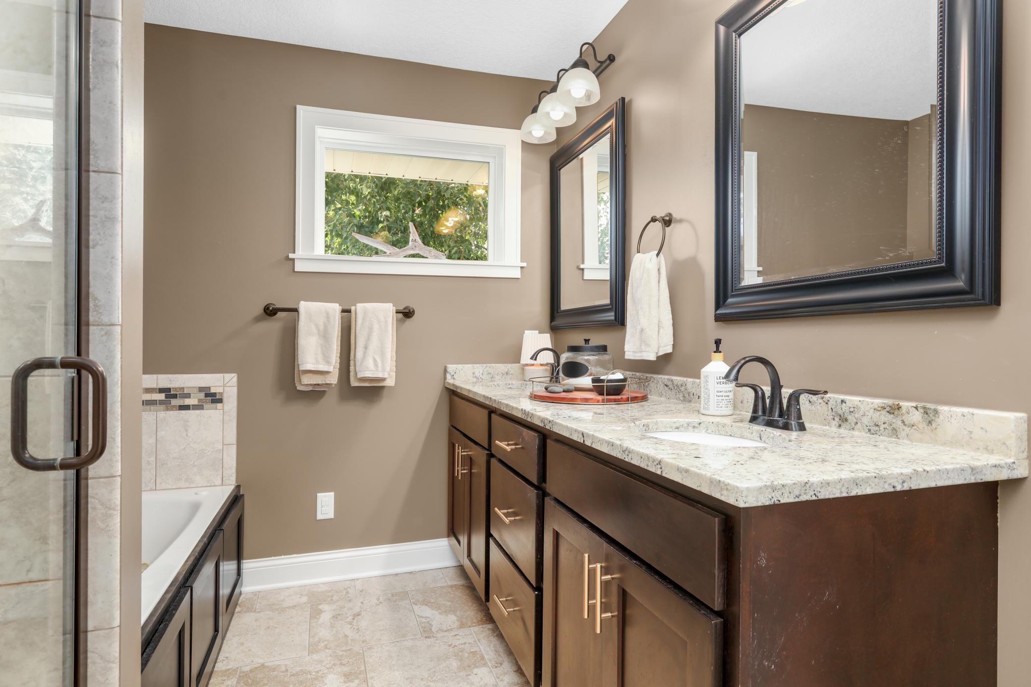 Primary bathroom suite with separate tub and walk in shower.