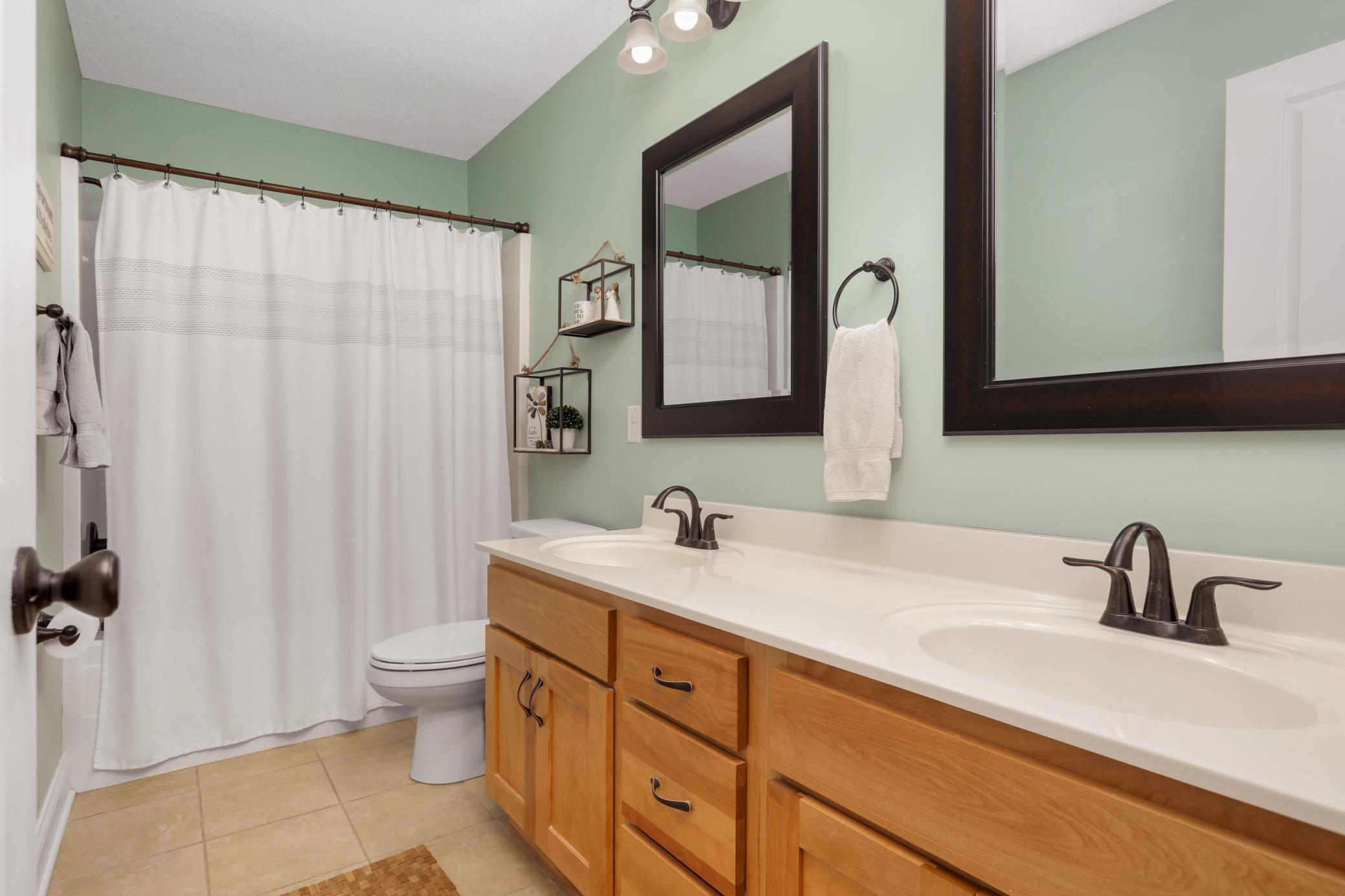 The second bathroom upstairs also features dual sinks!