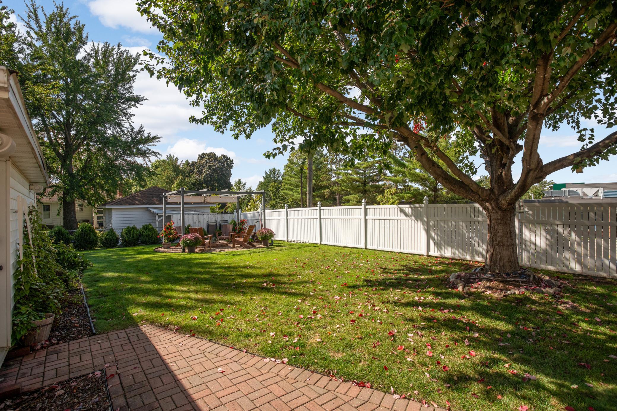 The large backyard has a deck, patio and pergola, perfect for a firepit!