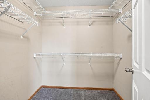 Walk-in closet in primary suite.