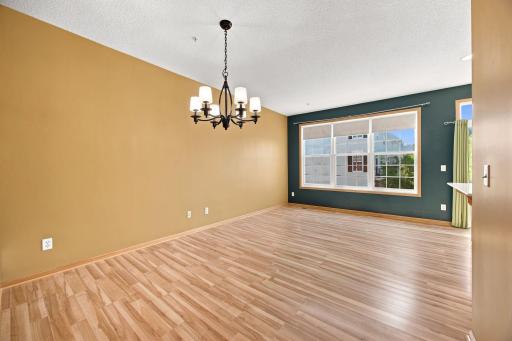 Dining room with space for a conversation area in front of windows.