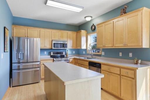 Open kitchen with center island & tons of cupboards