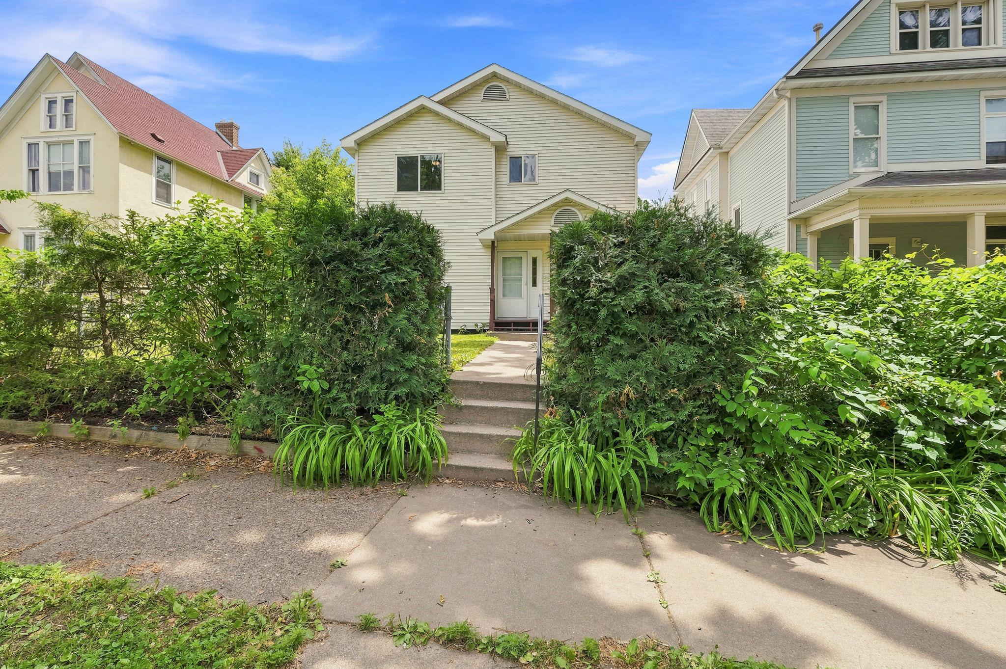 Fully fenced yard with hedges for privacy