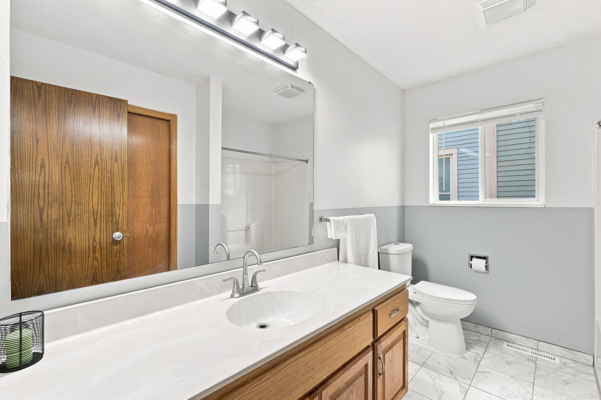 Main level bathroom has a large closet behind the door