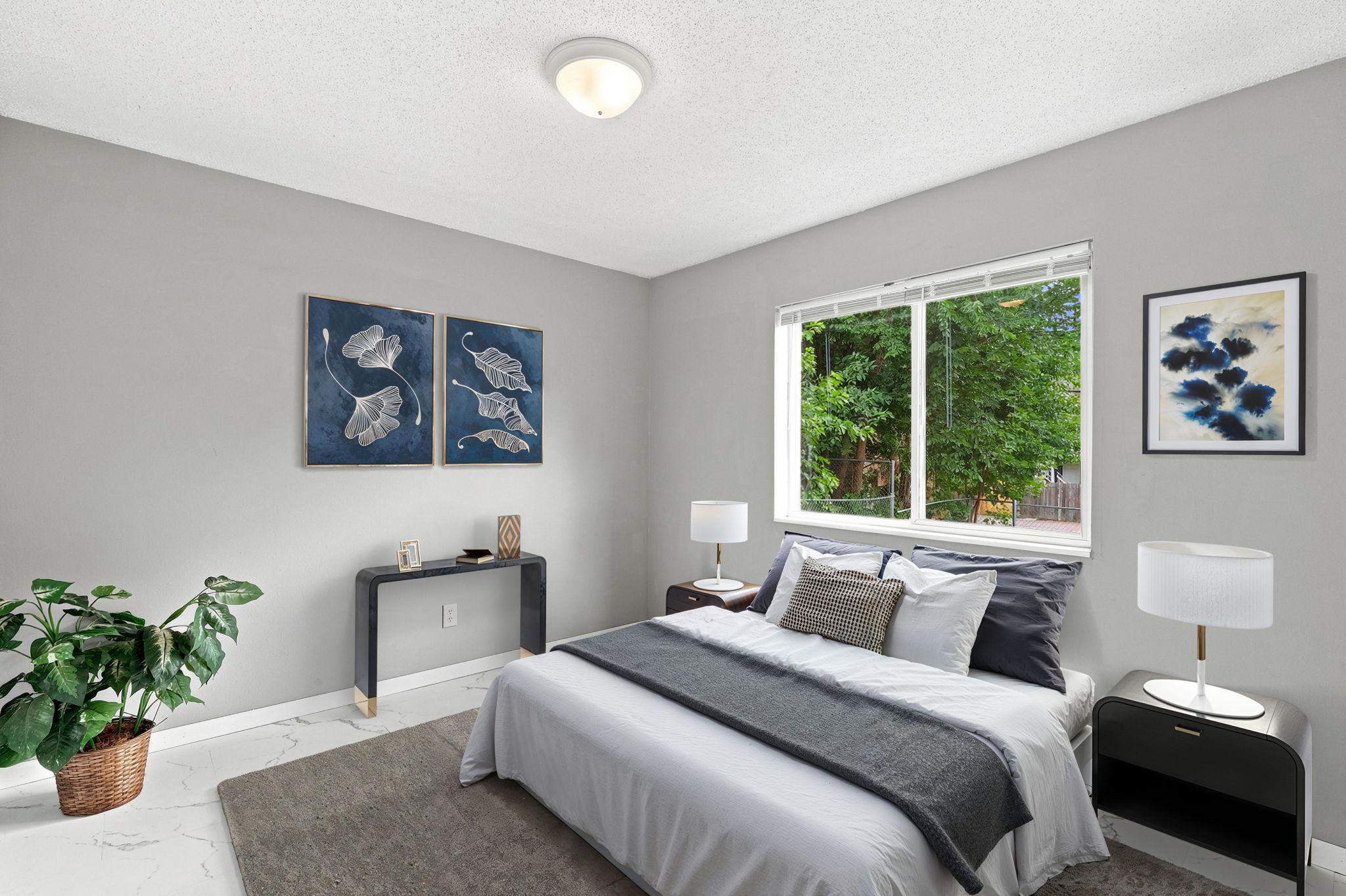 Digitally staged main level bedroom