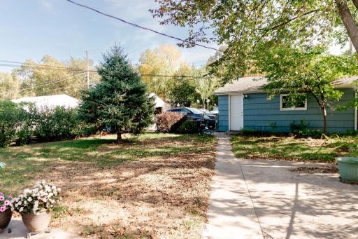 Nice large backyard fully fenced with newer concrete patio and walkways to single stall garage!