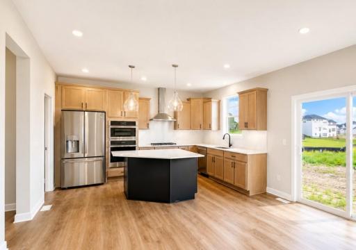 (Photo is of the actual home.) Enjoy meals of any kind in the dining room, situated among the open floorplan for effortless flow between cooking, dining and relaxing.