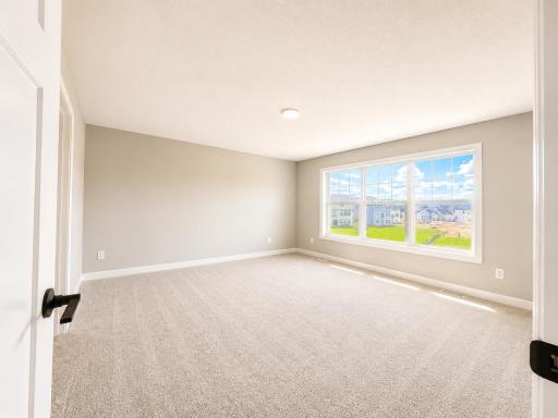 (Photo is of the actual home.) The owner’s suite is found on the second floor, complete with a cozy bedroom, an en-suite bathroom and a walk-in closet.