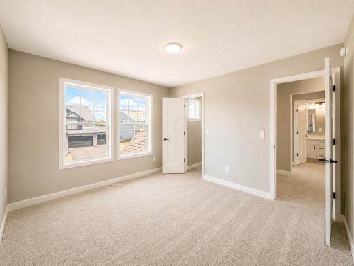 (Photo is of the actual home.) Three secondary bedrooms can be found upstairs, just down the hall from the owner’s suite.
