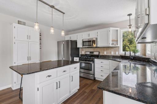 Spacious kitchen with granite countertops.