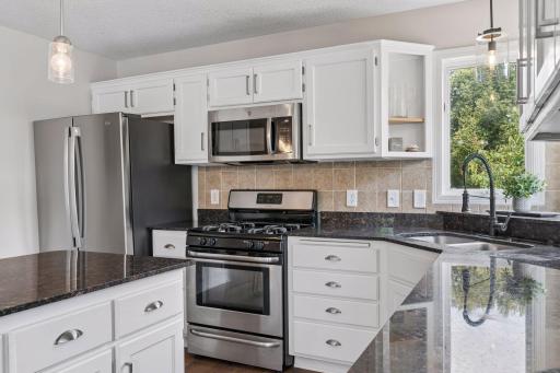 Stainless steel appliances with brand new fridge and dishwasher and gas stove.
