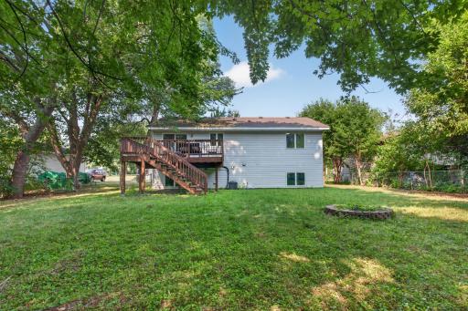 spacious fenced in back yard with mature trees