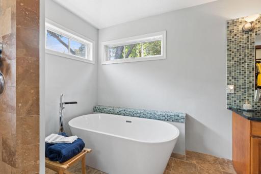 Relaxing soaking tub and tile flooring.accent the bathroom.