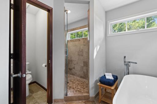 Bathroom also features a spacious tiled walk-in shower complete with natural lighting.