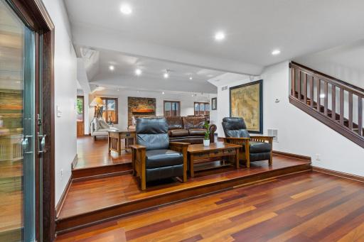 Family room area features tiered seating that offers excellent viewing angles, creating a comfortable, theater-style setting perfect for movie nights and entertaining.