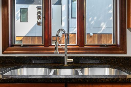 Three compartment stainless steel kitchen sink for added convenience.