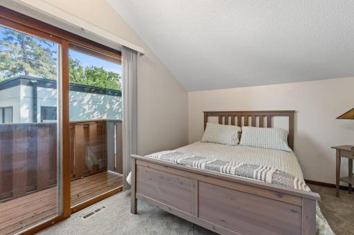 The fourth bedroom features a private balcony accessed through sliding glass doors.