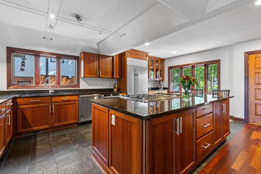Spacious gourmet kitchen showcases abundant custom cabinetry.