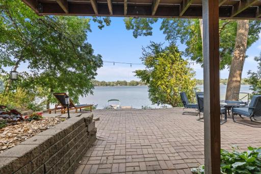 The lower-level patio offers a spacious outdoor area with plenty of room for lounging, relaxing, and entertaining guests while enjoying the surrounding lakefront setting.