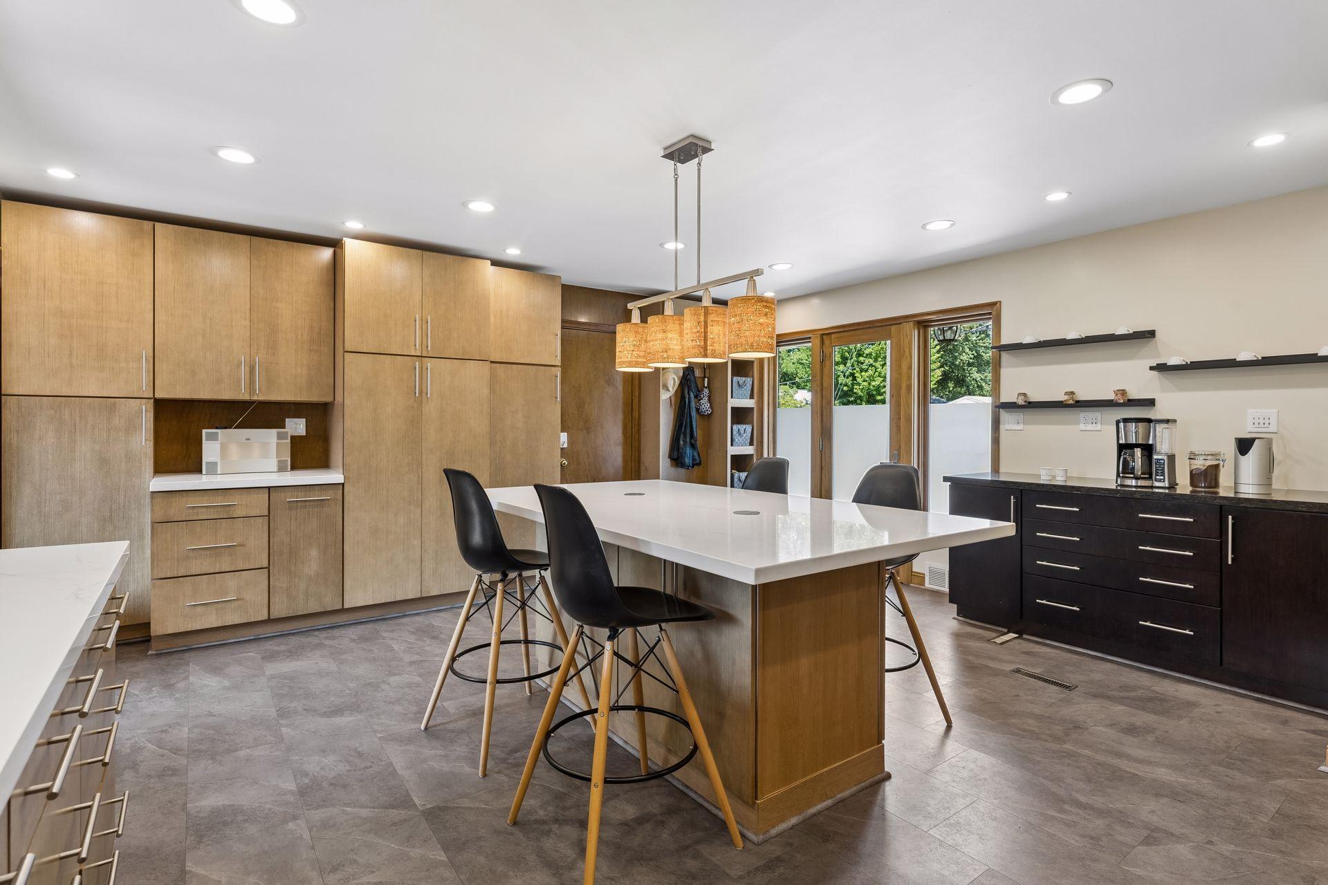 Abundant storage shines with wall-to-ceiling cabinetry, complemented by a stylish coffee bar area for added function and convenience.