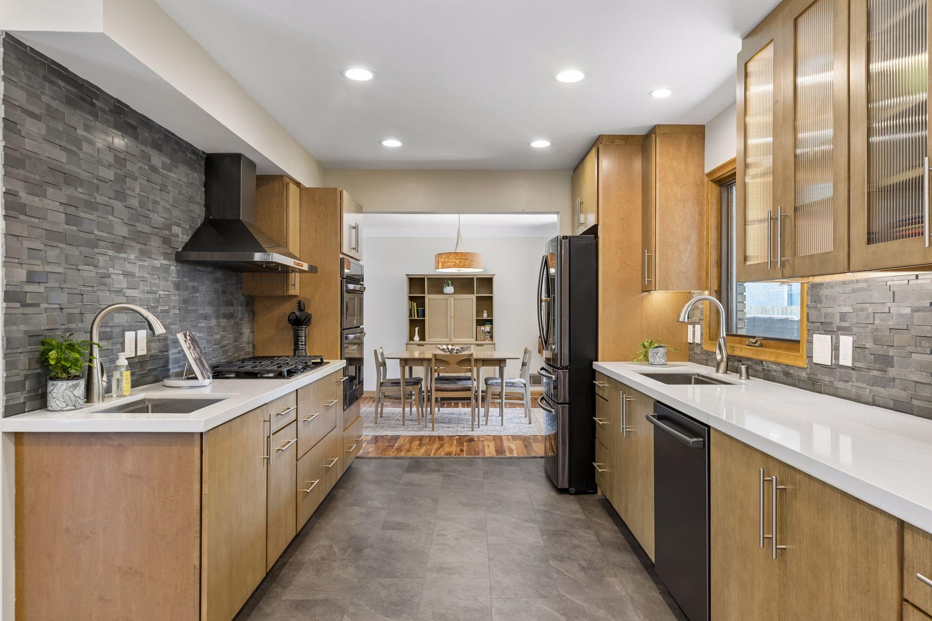 Stunningly remodeled kitchen featuring custom cabinetry, quartz countertops, and a beautiful stone backsplash, creating a stylish and functional space.