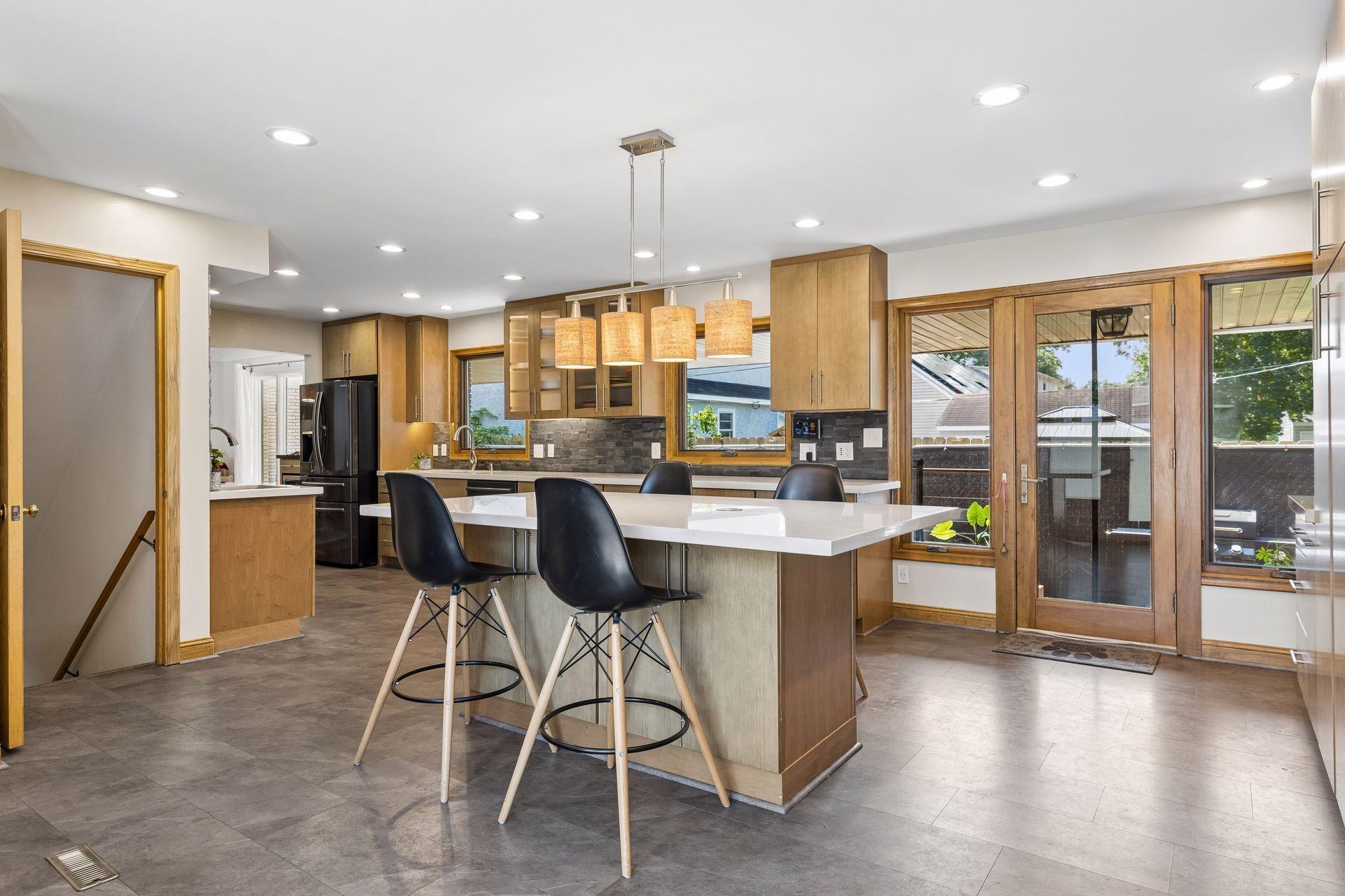 A spacious kitchen island provides versatile prep space and convenient seating, perfect for casual meals or entertaining.