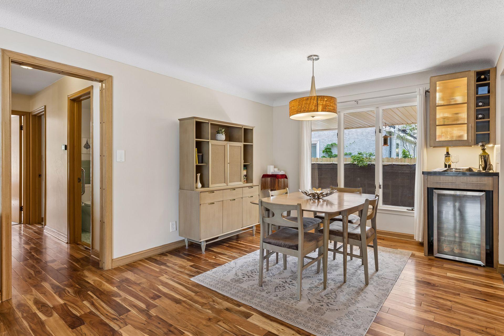 Bright and inviting, the dining area features a convenient bar area with additional cabinet storage and a built-in wine rack—perfect for entertaining and everyday living.