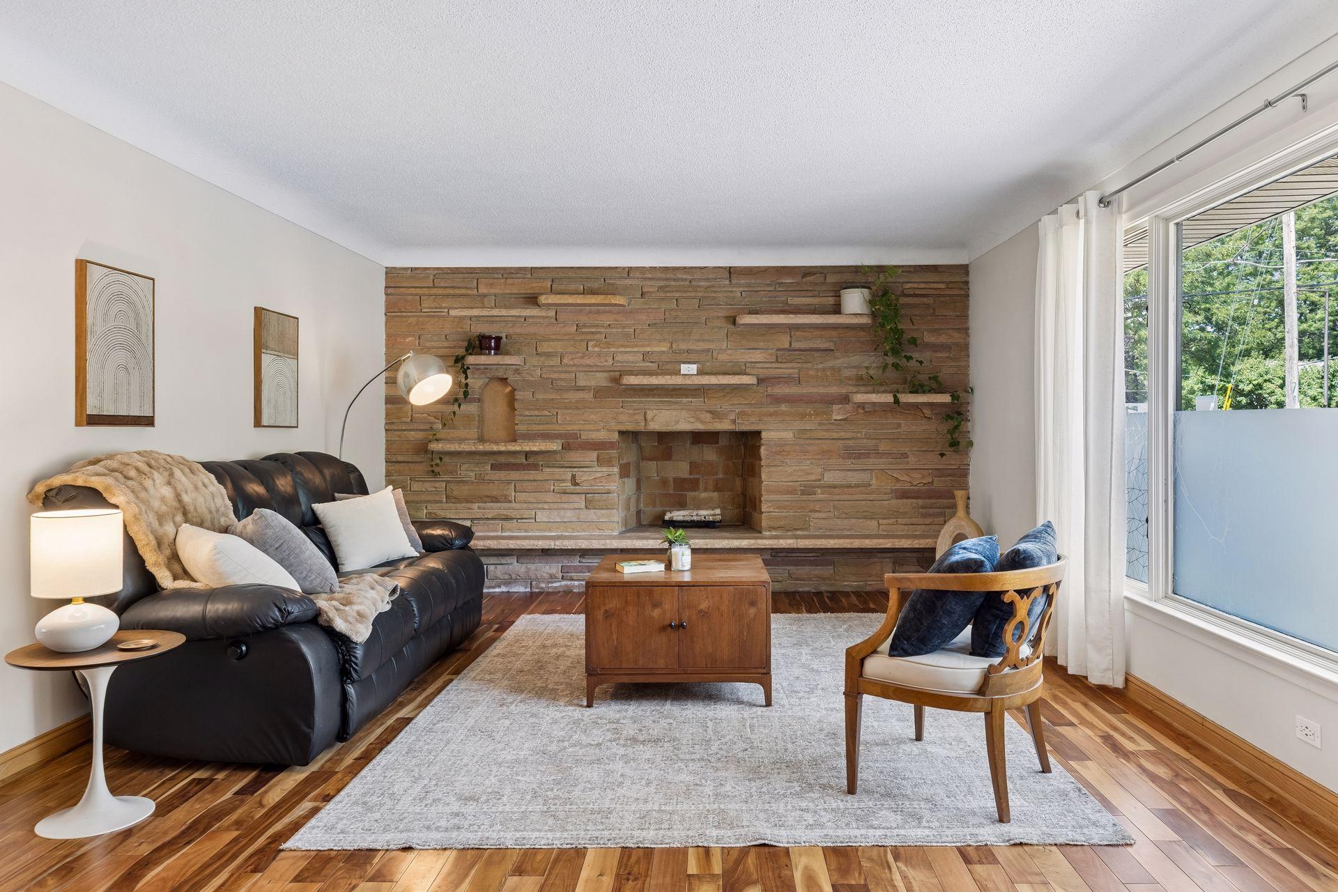Beautiful stone-accented fireplace with built-in shelving adds warmth, character, and a welcoming focal point to the space.